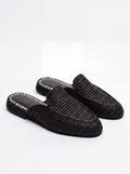 A pair of black woven slip-on mule loafers with gold-tone decorative stitching along the edge of the sole, displayed on a clean white background.