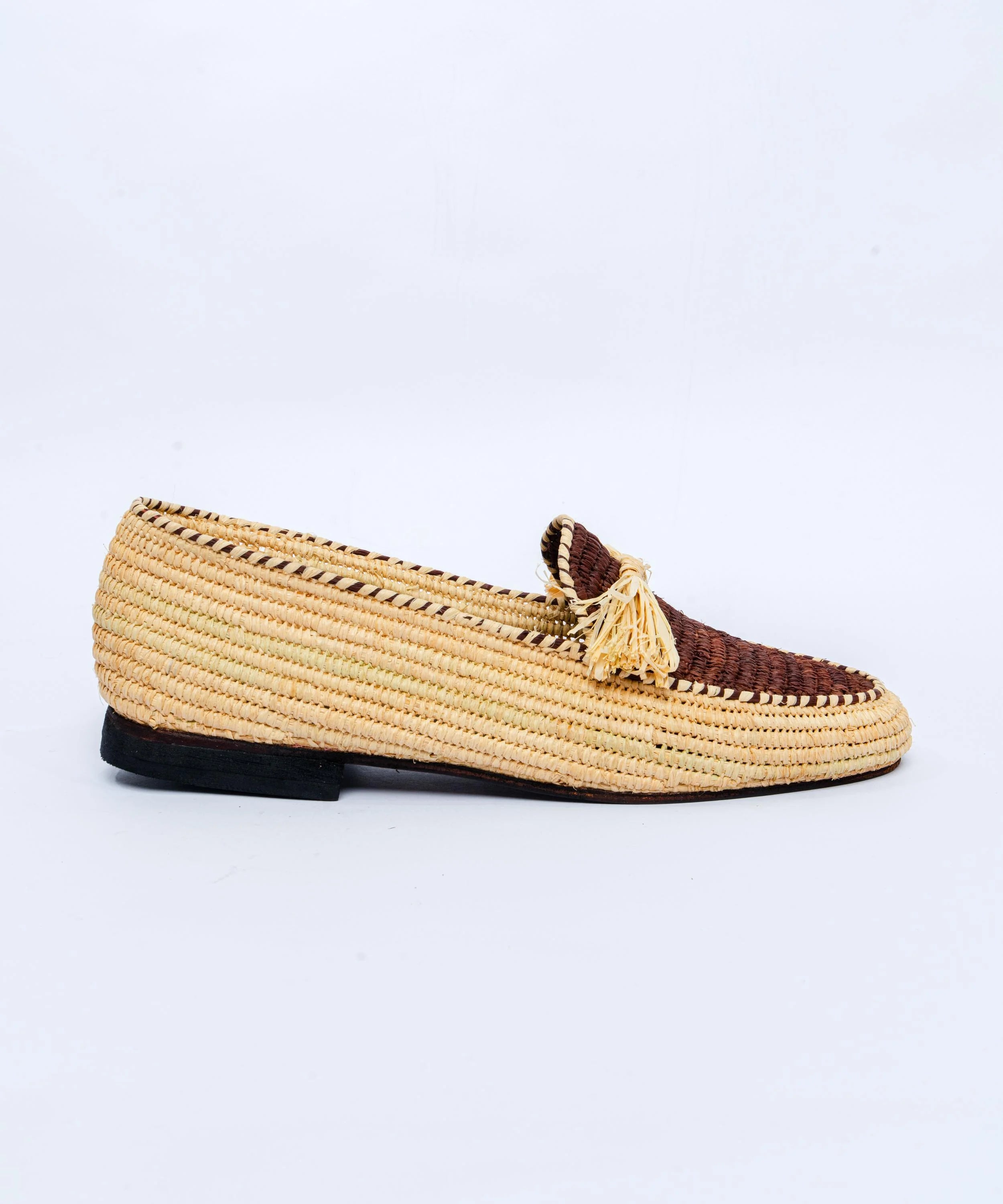Woven loafer with a tassel on a light gray background