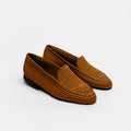 A pair of brown woven slip-on loafers with black soles, photographed on a clean white background.