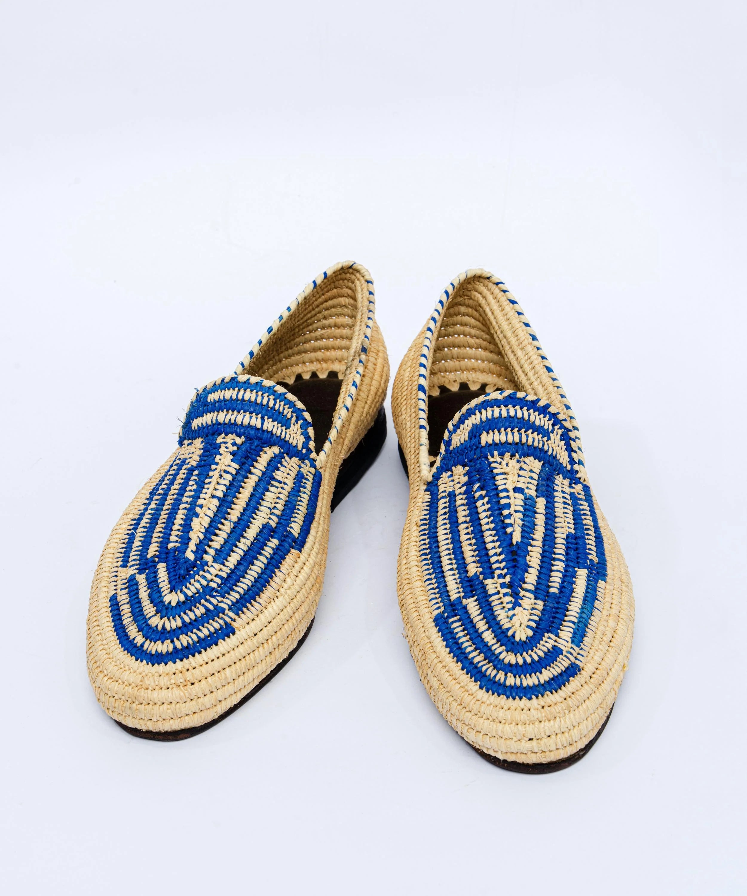 Pair of woven shoes with blue patterns on a white background