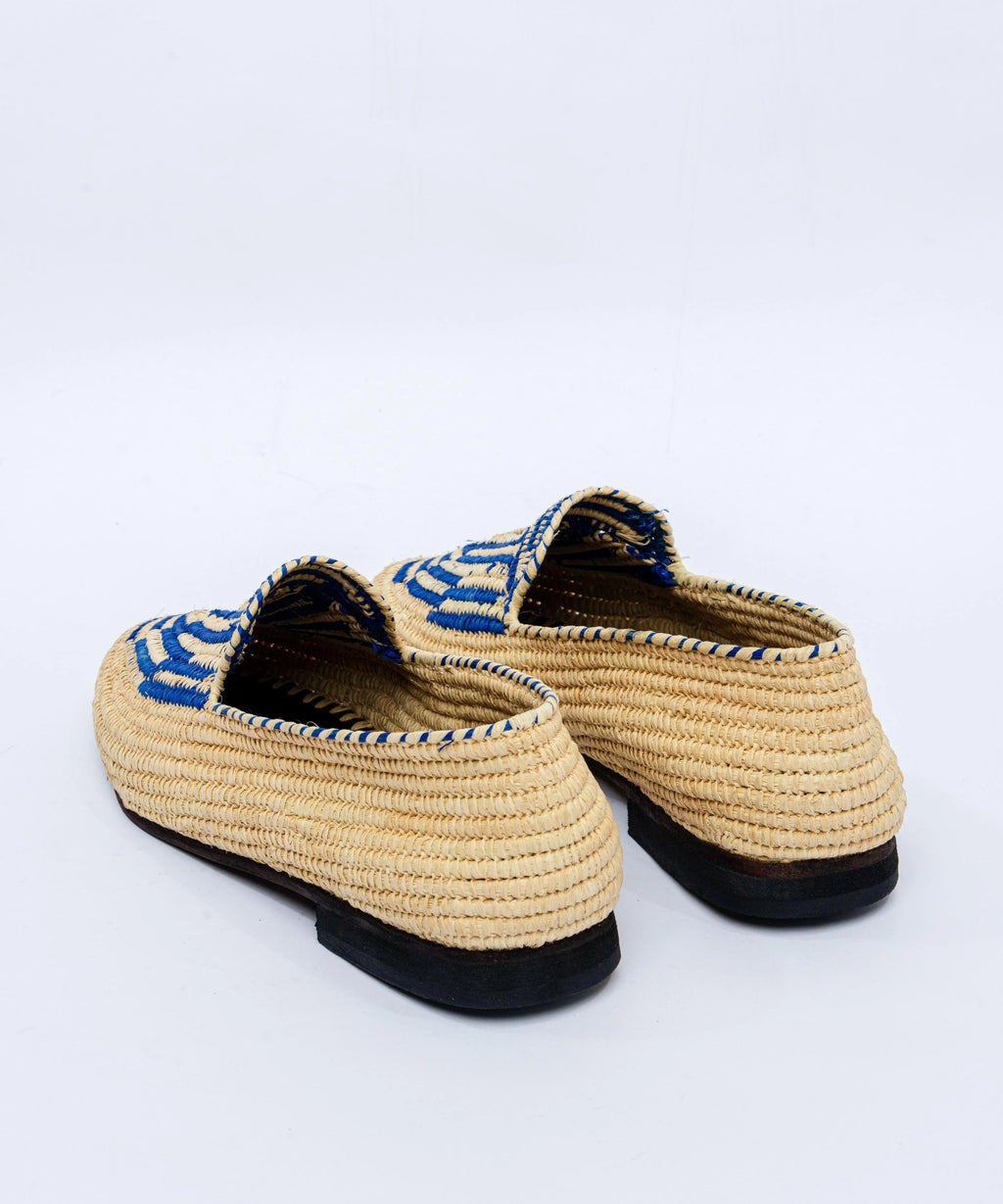 Pair of woven shoes with blue accents on a white background