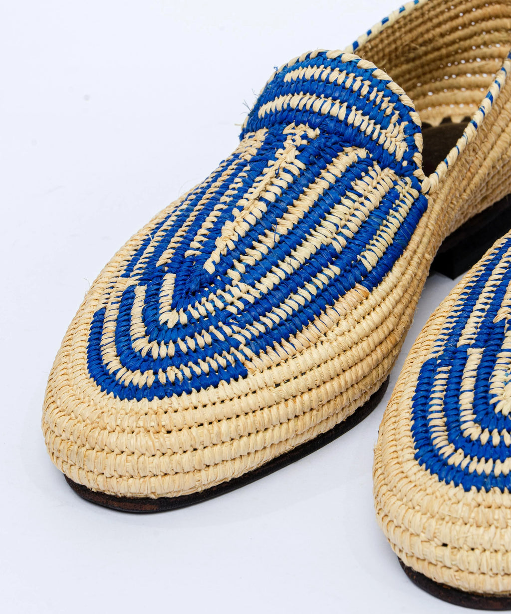 Woven shoes with blue and beige pattern on a white background