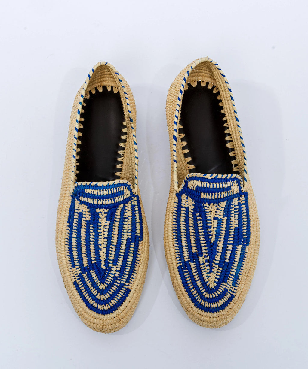 Pair of woven shoes with blue patterns on a white background