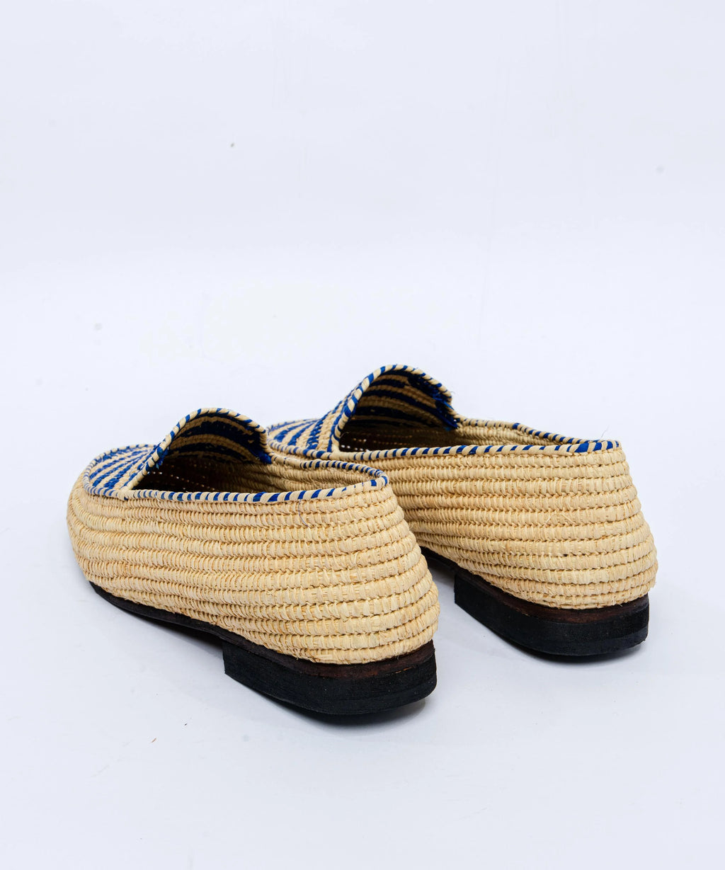 Pair of woven shoes with black soles on a white background