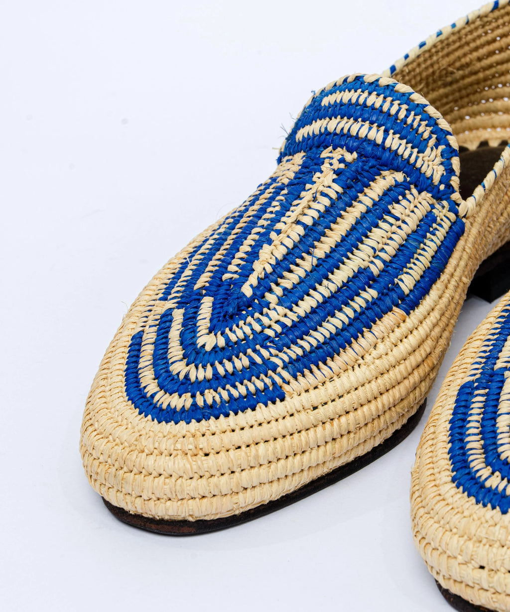 Woven shoes with blue and beige pattern on a white background