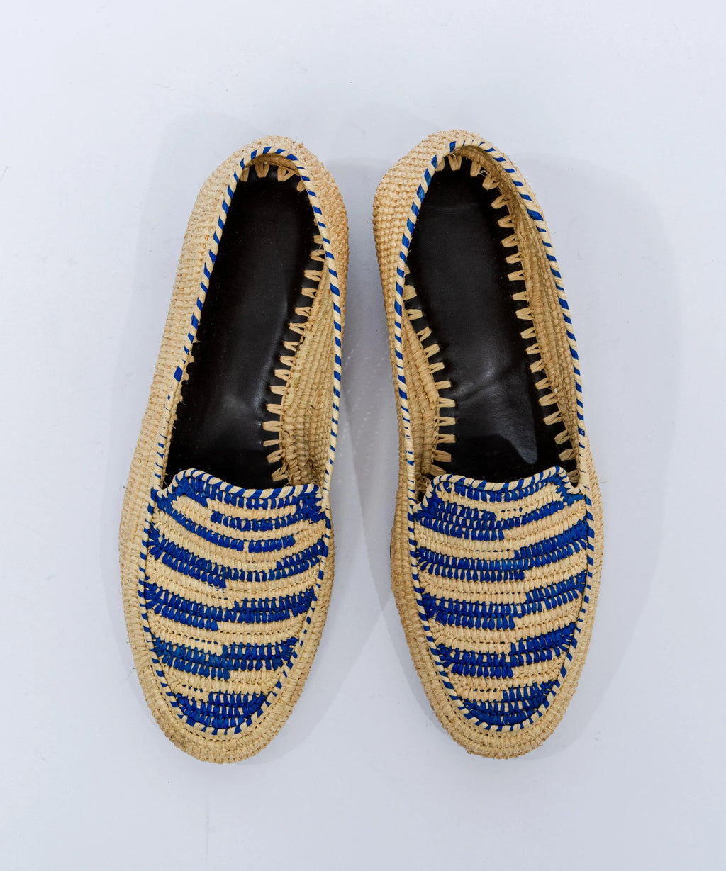 Pair of woven shoes with blue accents on a white background