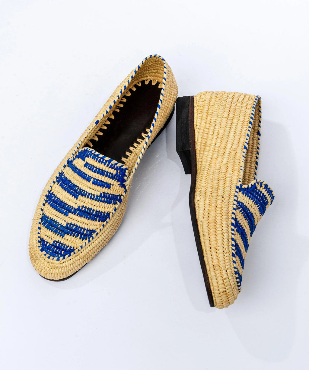 Pair of woven shoes with blue accents on a white background