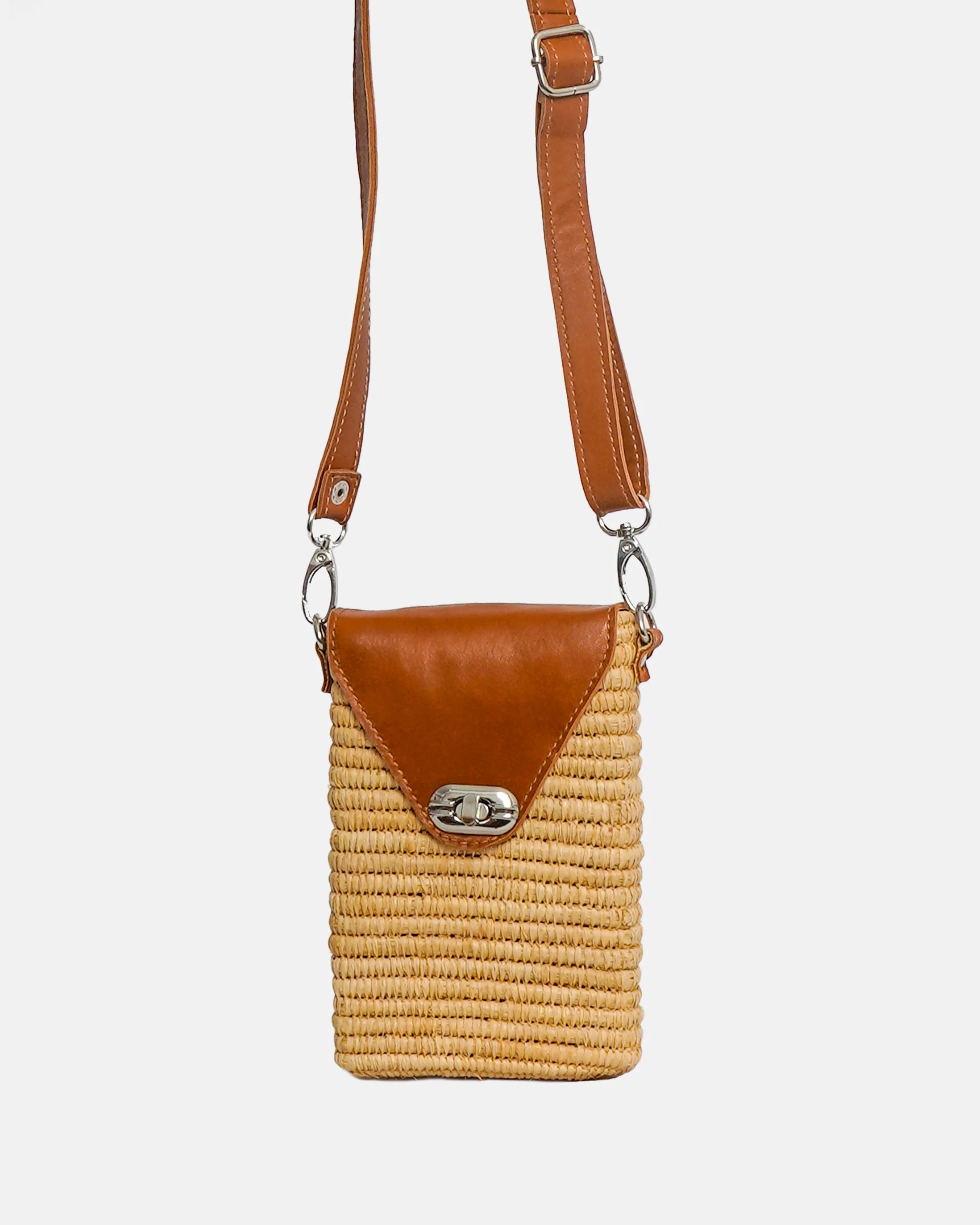 Woven handbag with brown leather accents on a white background