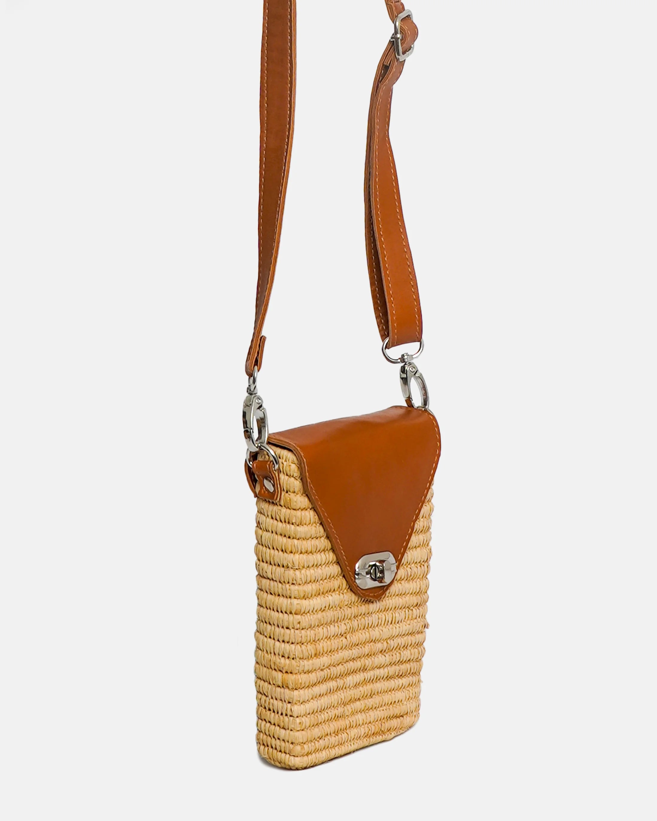 Woven bag with brown leather accents on a white background