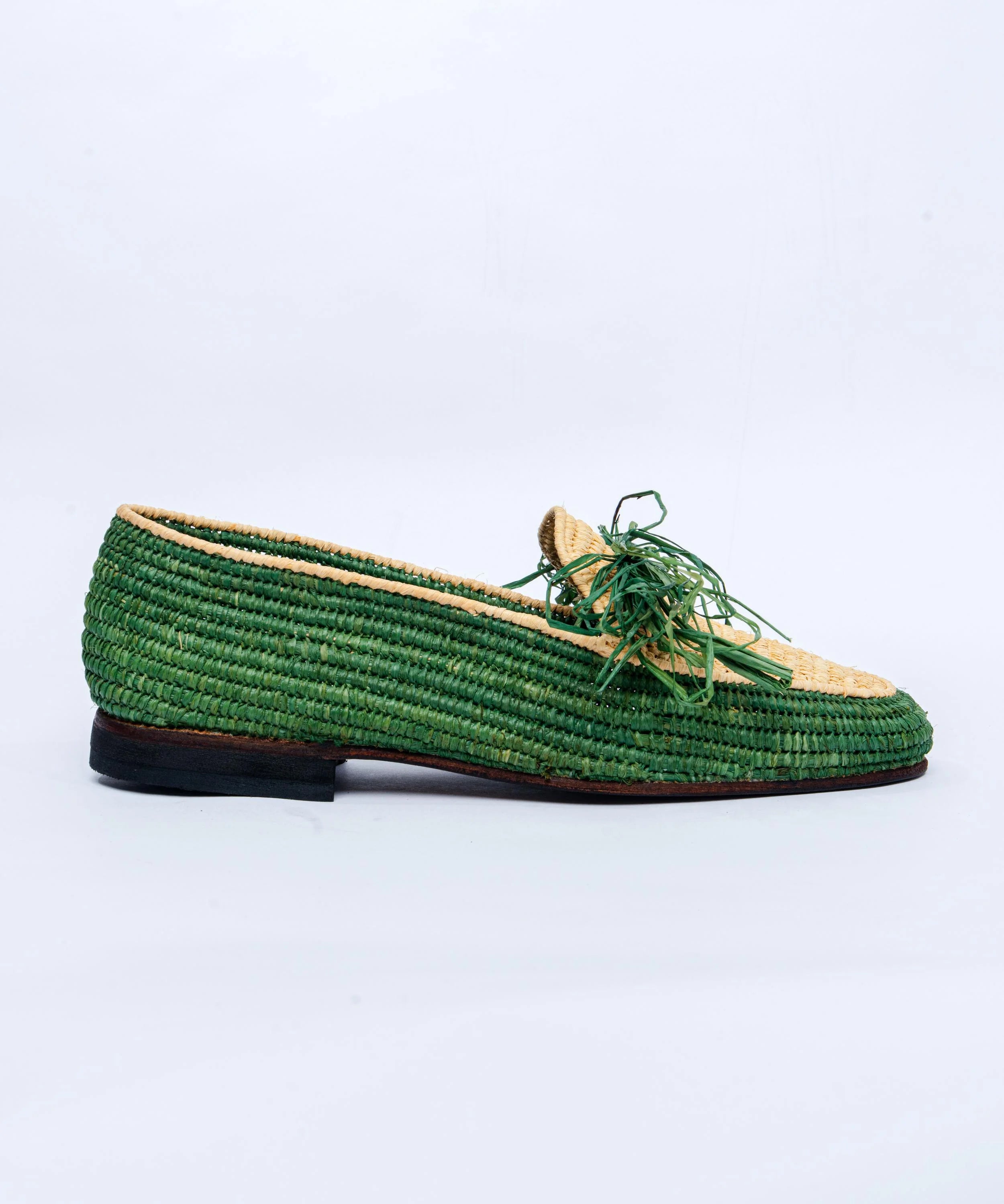 Green woven loafer shoe on a light gray background