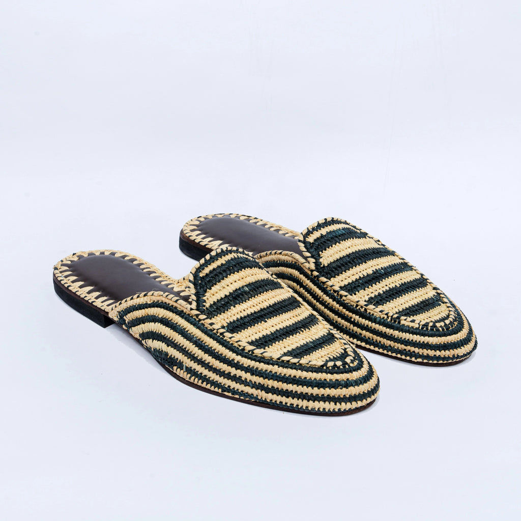 Pair of striped slippers on a light gray background
