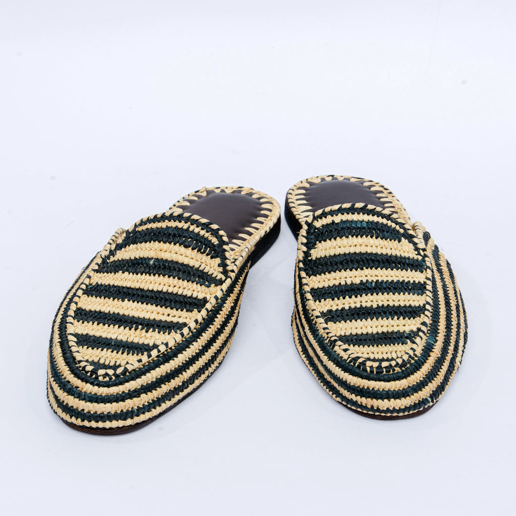 Pair of black and beige striped slippers on a white background