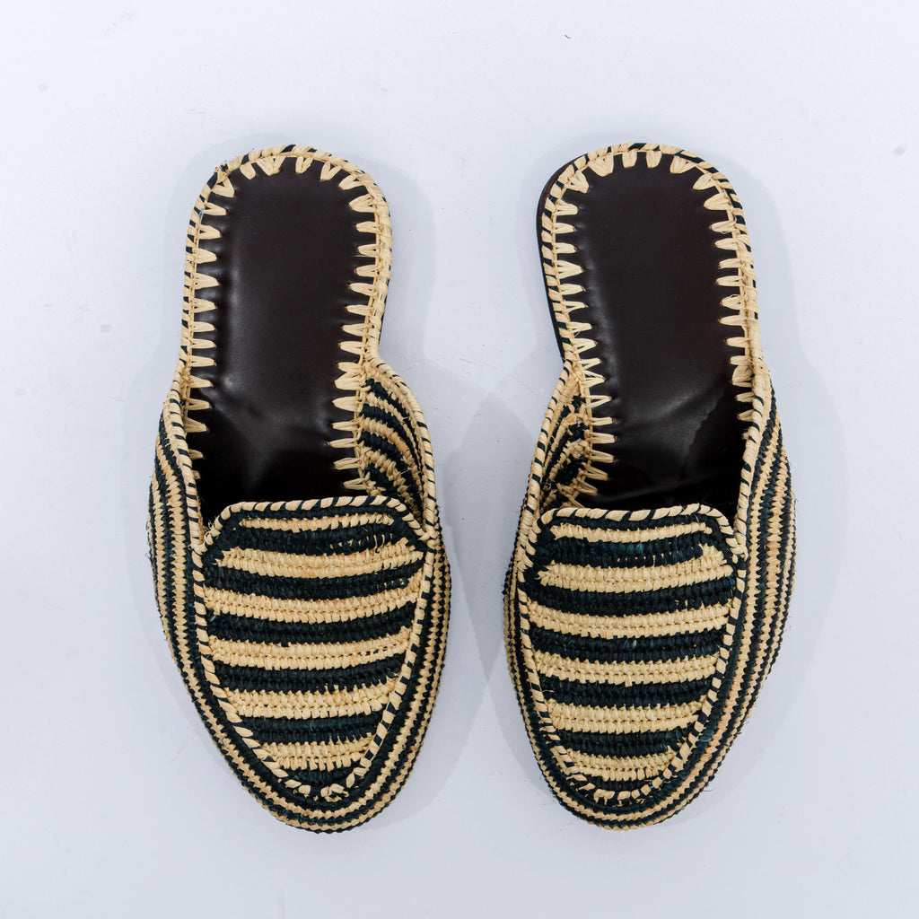 Pair of black and beige striped espadrille shoes on a white background
