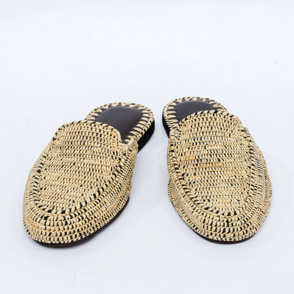 Pair of woven slippers on a white background