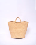 Woven straw bag on a white background