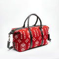 A red and white patterned duffel bag with black leather handles and straps, shown on a clean white background.