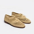 A pair of woven straw lace-up shoes with a brown sole, photographed on a clean white background.