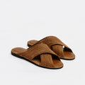 A pair of brown woven slide sandals with crisscrossing straps and dark soles, displayed on a clean white background.